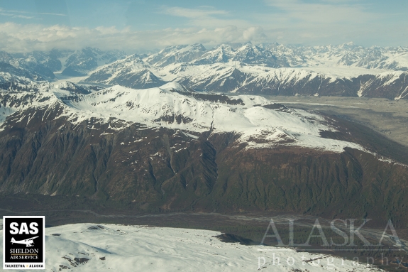 Where Kanikula Creek meets with the Tokositna River, Tokositna Glacier in the background. South end of The Rooster Comb in the clouds.