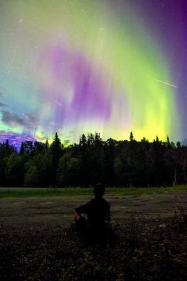 Watching the northern lights one August night from along the Alaska Highway on our guided tour.