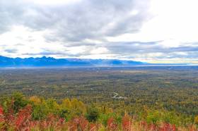 Looking down on the parking lot from Blueberry Knoll Trail Palmer to the left and Cook Inlet to the right.