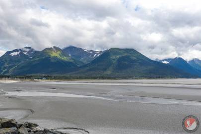 Baumann Bump is the center peak with sunlight on it, with Mount Alyeska on its left and Hibbs Peak disappearing in the clouds on its right.