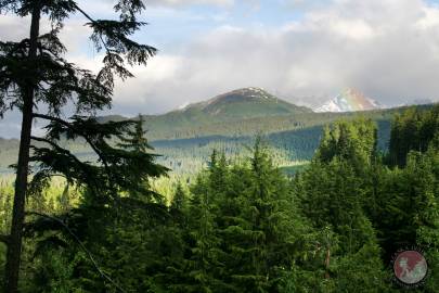 A rainbow appears to the south(left) of Sunshine Mountain. Haines, Alaska.