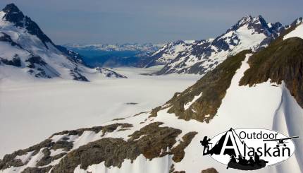 Looking west across McConnell Ridge, with Muir Inlet behind it, and Thunder Ridge (cliffs opposite inlet, on right side), Minnesota Ridge behind the top left of McConnell. All from above McBride Glacier.