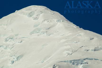 The four climbers climb the east ridge, looking at the southeast face of Mount Crosson.