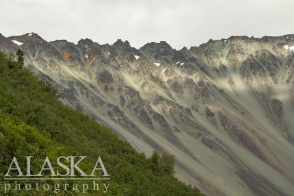 The sun breaks through and lights up Rainbow Ridge. As seen from the Richardson Highway.